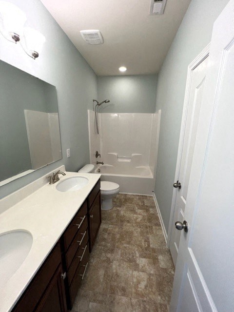 a bathroom with two sinks and a toilet and a shower