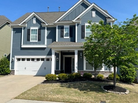 a blue house with a white garage door