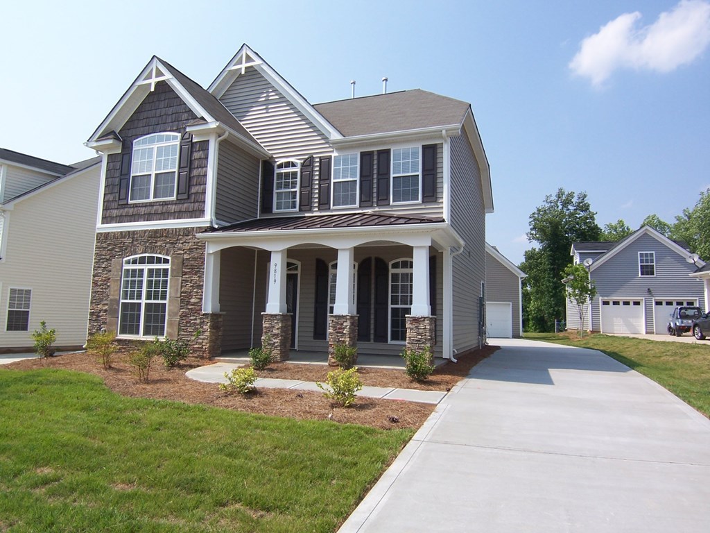 a large house with a sidewalk in front of it