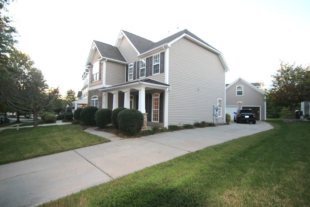 a house with a driveway and a car parked in front of it