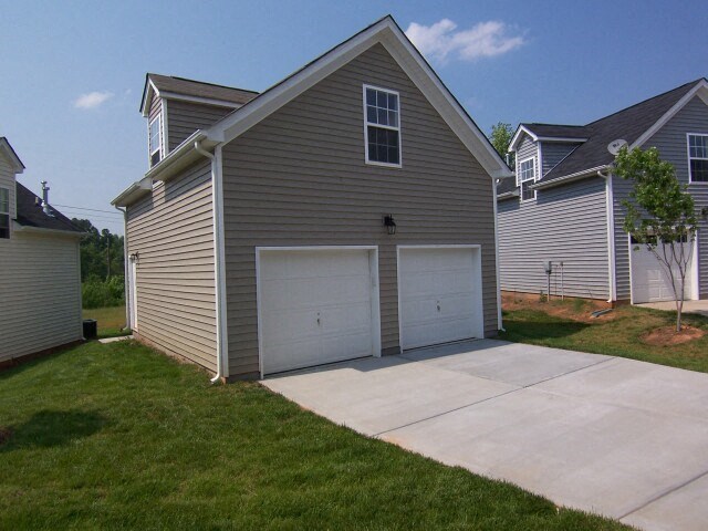 a gray house with a garage and a driveway