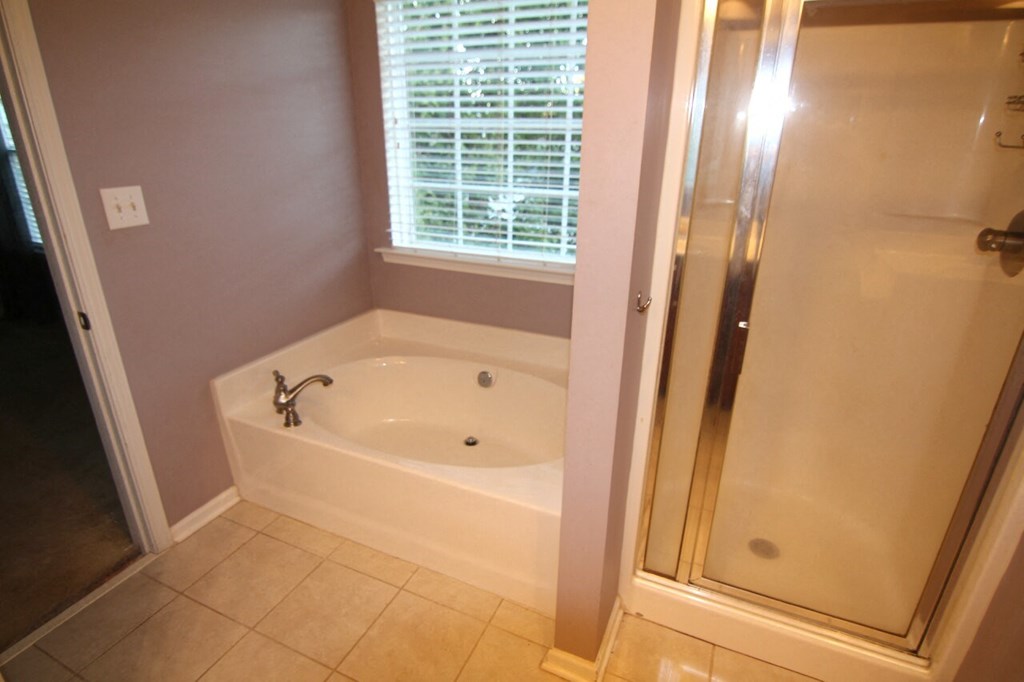 a small bathroom with a tub and a shower