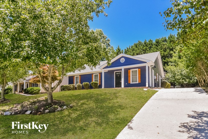 a blue house with a tree in front of it