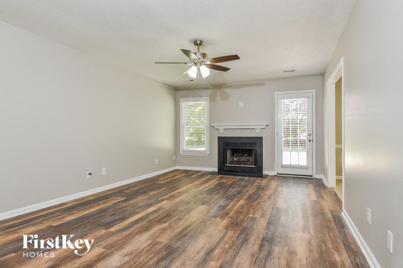 the living room with wood flooring and a fireplace