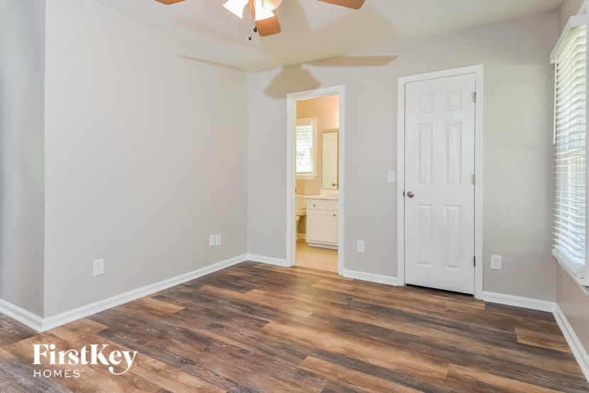 a living room with wood floors and a white door