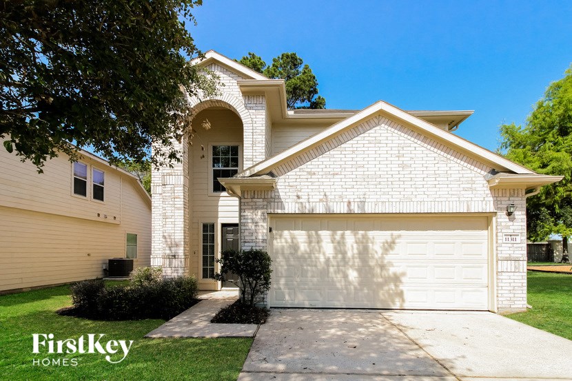 a white brick house with a white garage door