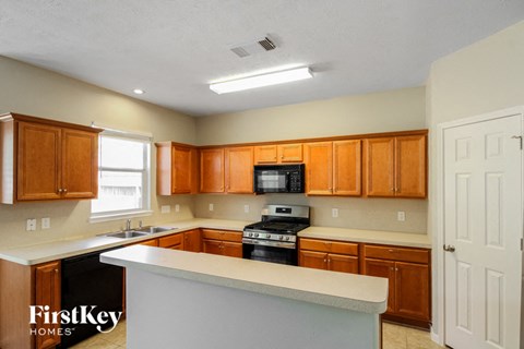 a kitchen with wooden cabinets and a white counter top