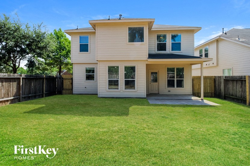 a white house with a yard and a fence