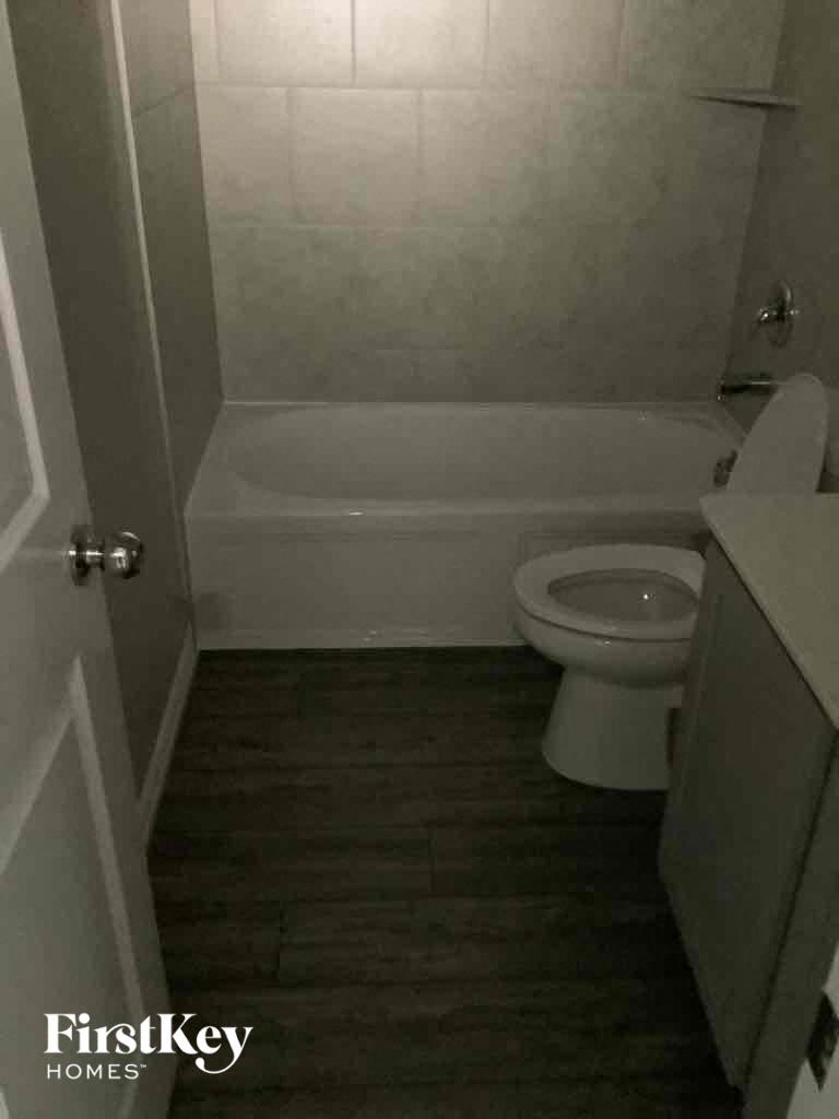 a small bathroom with a toilet and a bath tub