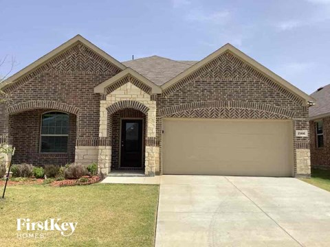 front view of a brick house with a garage door