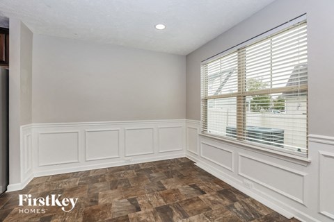 a living room with a large window and white walls