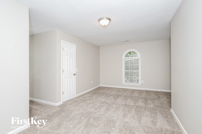a bedroom with carpeted floors and a white door