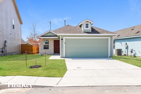 a house with a driveway and a green garage door