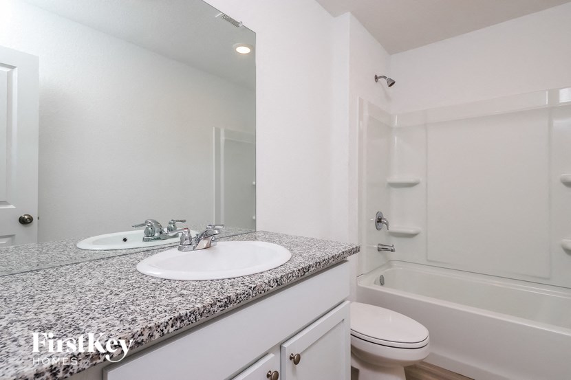 a bathroom with a sink and a toilet and a shower