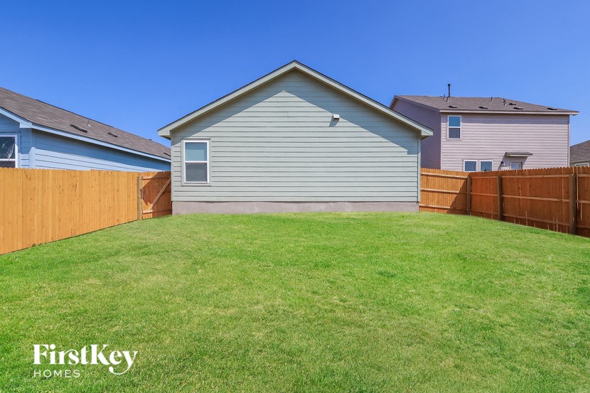 a fisheye view of a backyard with a fence and a house