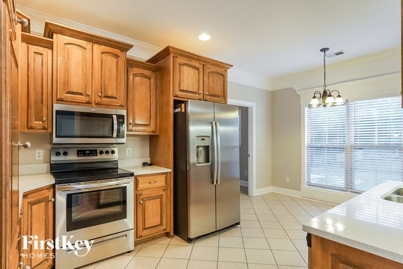 a kitchen with wooden cabinets and stainless steel appliances