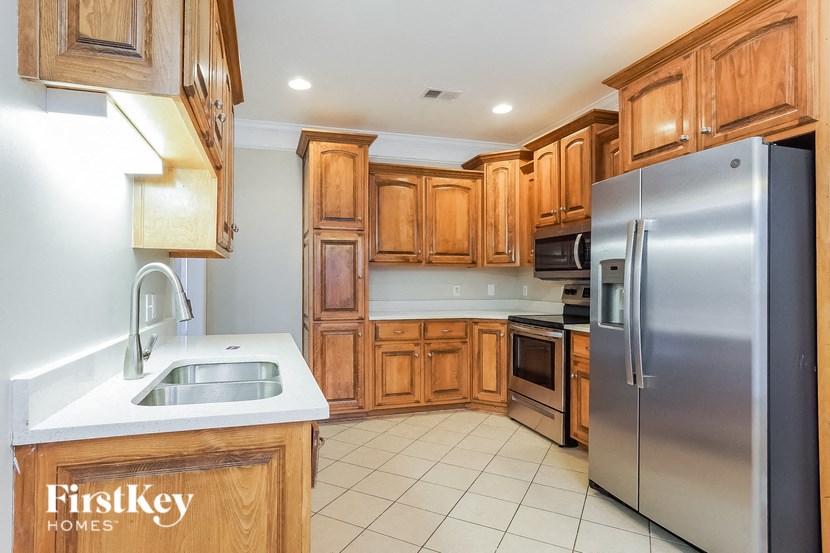 a kitchen with wooden cabinets and stainless steel appliances