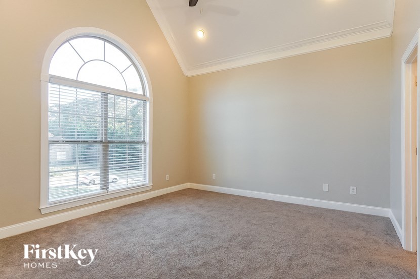 an empty living room with a large window