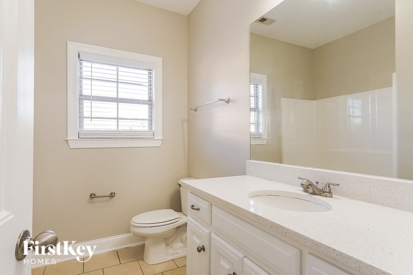 a bathroom with a toilet and a sink and a mirror