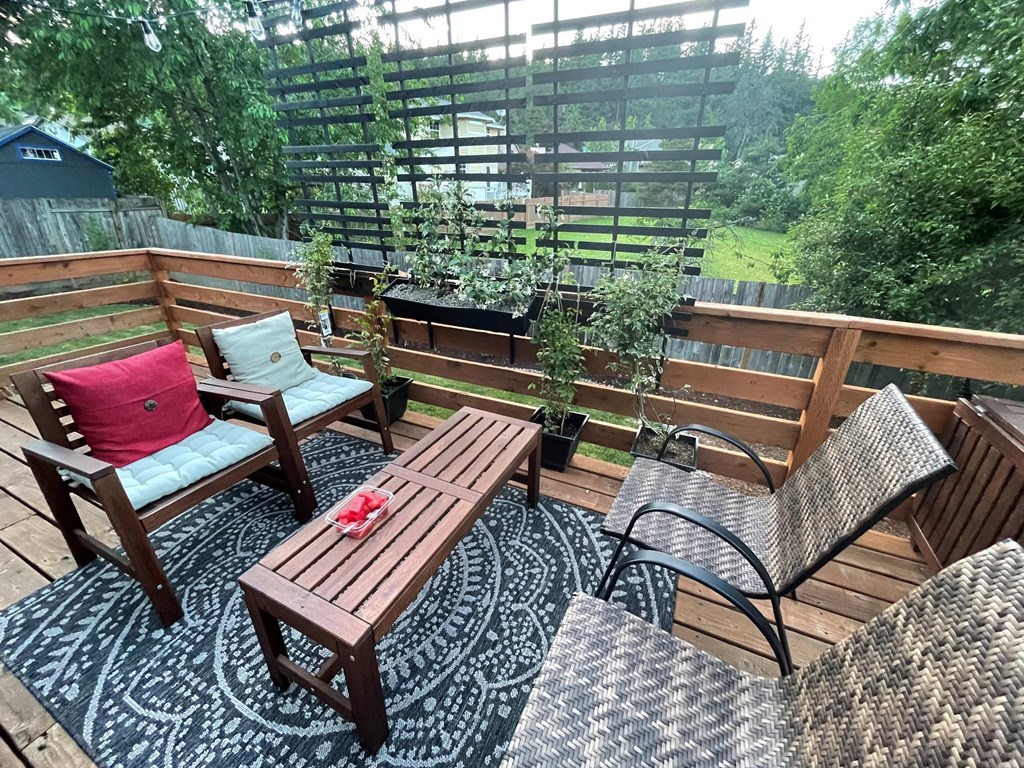 a patio with a table and chairs on a deck