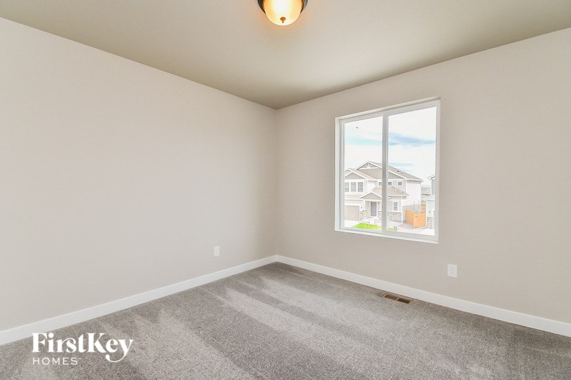 the living room with carpet and a large window