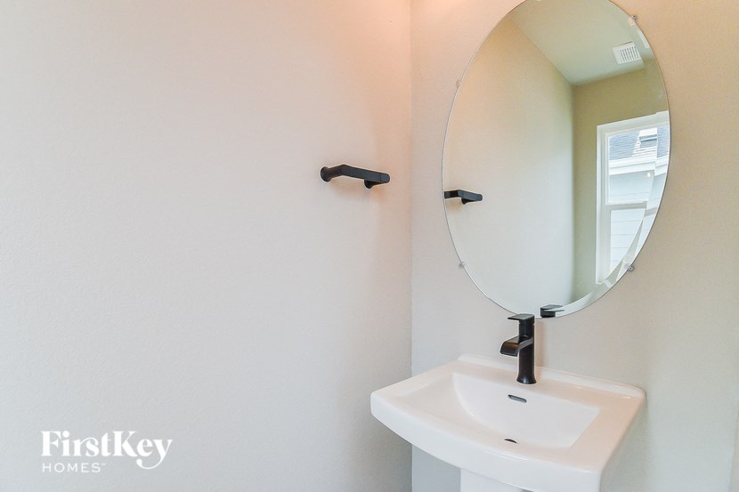 a small bathroom with a mirror and a sink