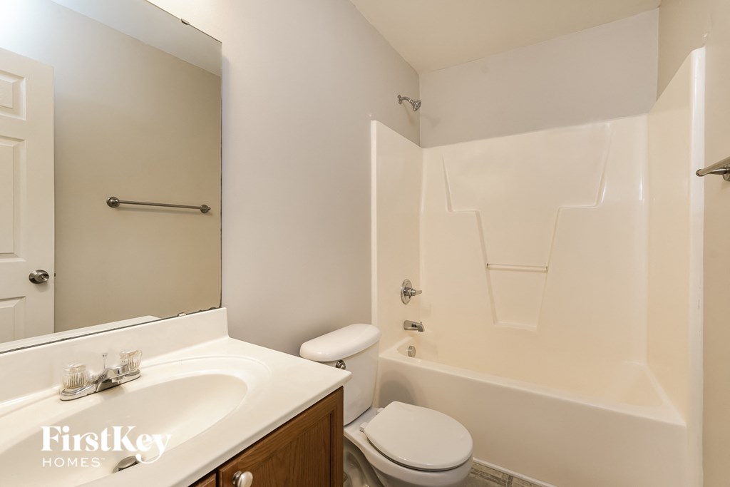 a bathroom with a sink and a toilet and a bath tub