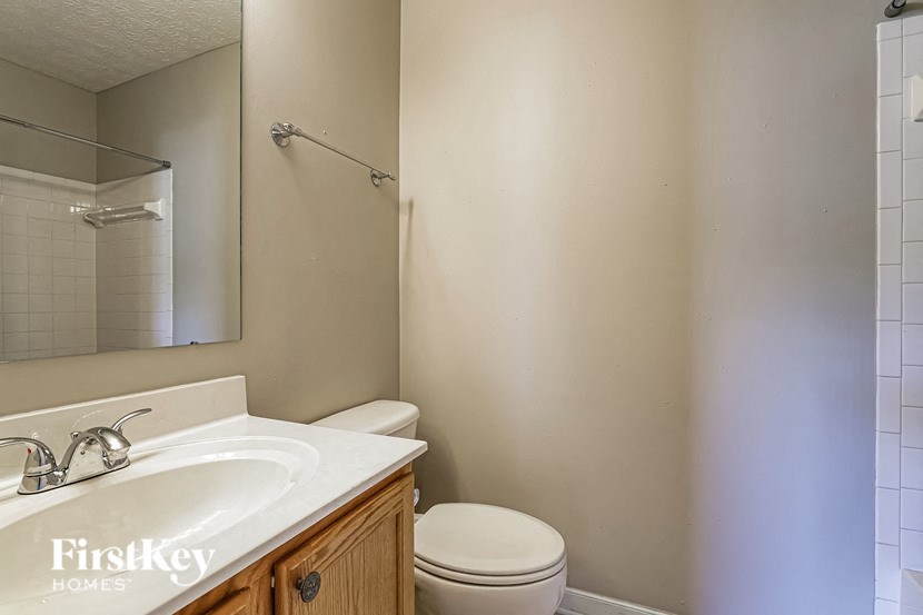 a bathroom with a sink toilet and a mirror