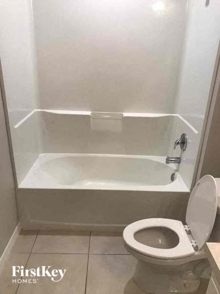 a small bathroom with a toilet and a bath tub