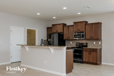 A kitchen with a white counter and brown cabinets.