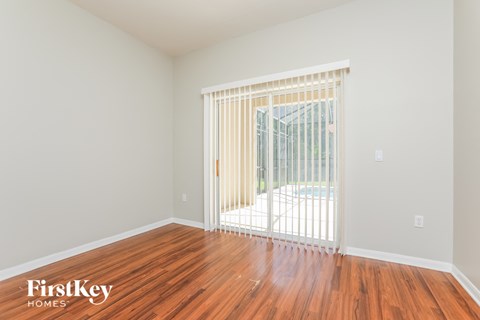 a living room with wood floors and a sliding glass door