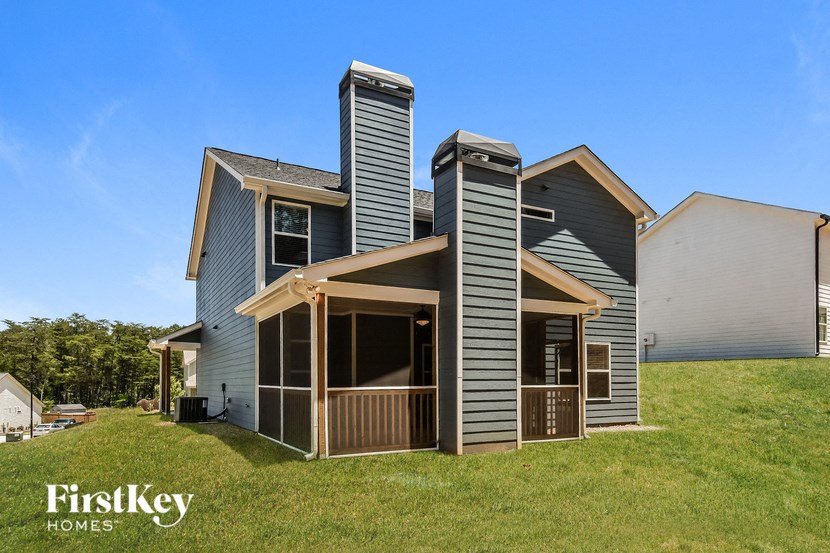 the front of a house with a garage and a porch
