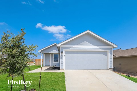 a home with a white garage door and a driveway