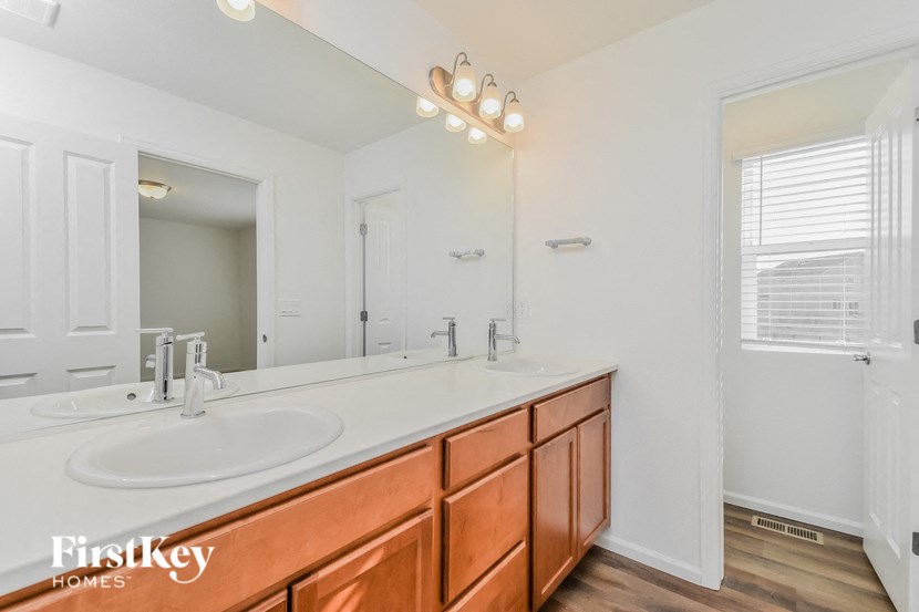 a bathroom with two sinks and a large mirror