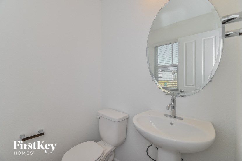 a small bathroom with a sink toilet and a mirror