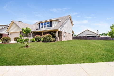 A house with a well-maintained lawn in front of it.