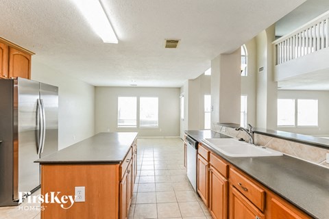 a large kitchen with wooden cabinets and stainless steel appliances