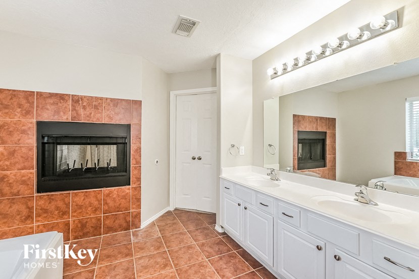 a bathroom with a white sink and a fireplace