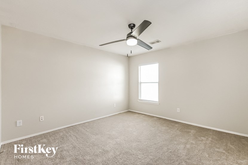 a room with a ceiling fan and a window