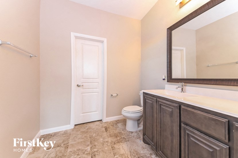 a bathroom with a toilet and a sink and a mirror