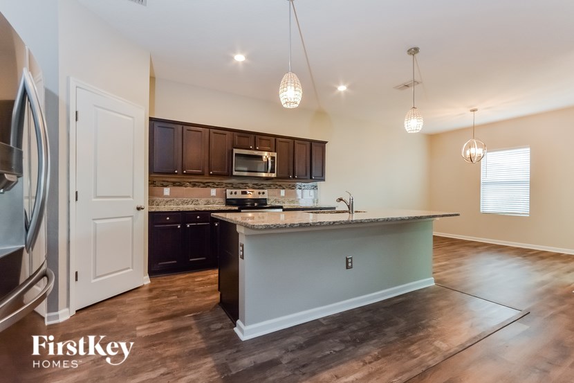 A kitchen with a countertop and cabinets is shown.