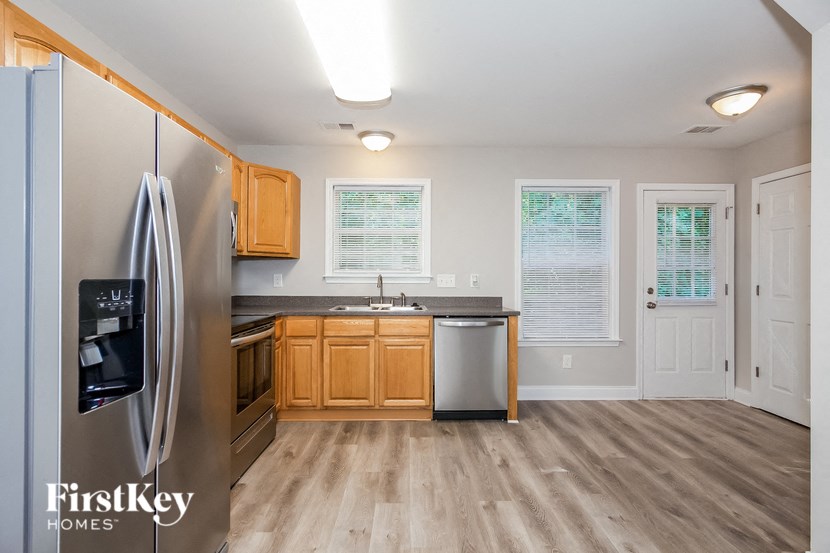 a kitchen with wooden cabinets and stainless steel appliances