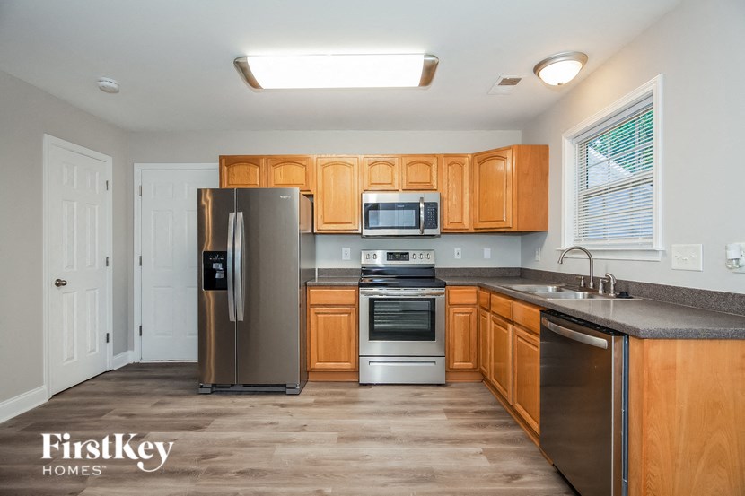 a kitchen with wooden cabinets and stainless steel appliances