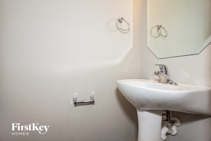 a white bathroom with a sink and a mirror
