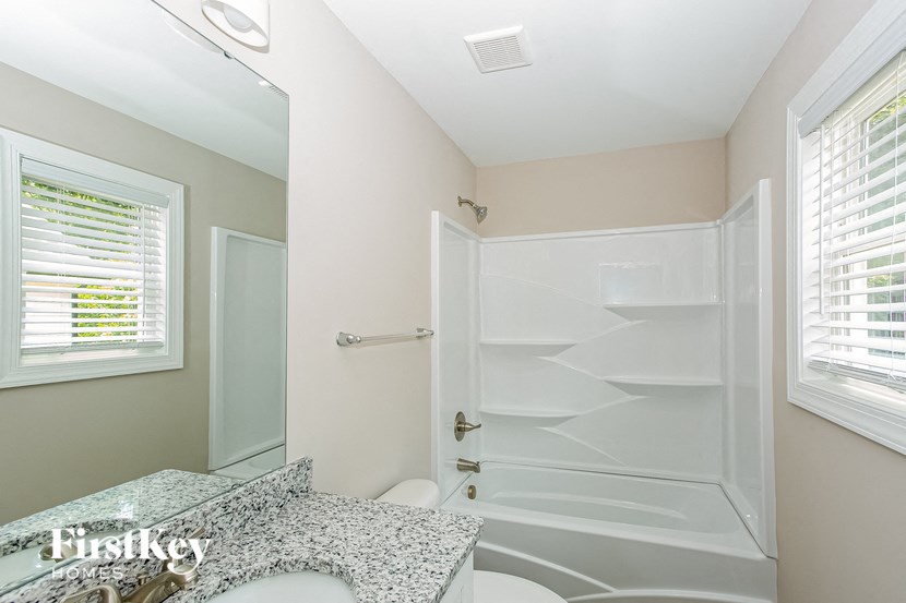 a bathroom with a shower and a sink and a toilet