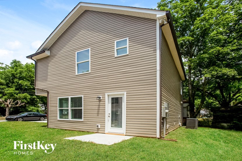 the front of a house with a garage and a yard