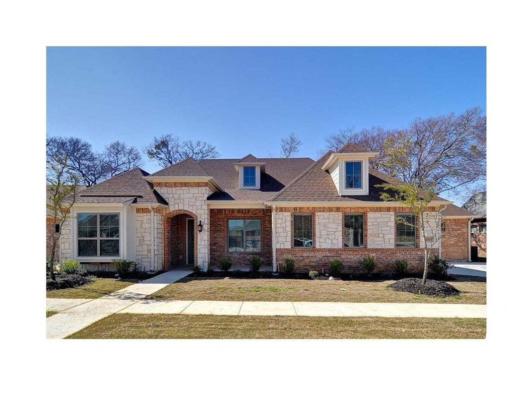 A house with a brown roof and a brick facade.