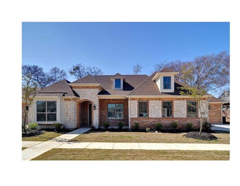 A house with a brown roof and a brick facade.