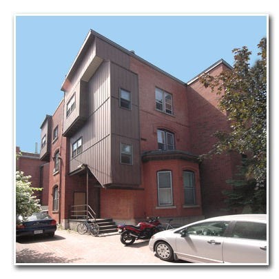 a building with a motorcycle and a car parked in front of it