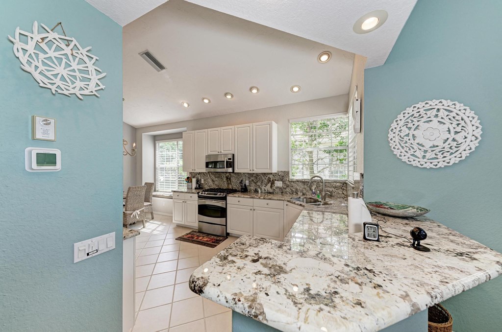 a view of a kitchen with a marble counter top